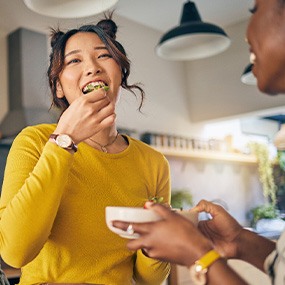 Group of friends enjoying meal in kitchen
