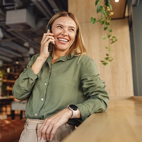 Woman smiling while talking on phone