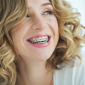 Woman with braces smiling brightly