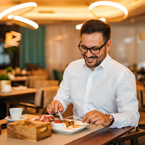 Man smiling while enjoying meal at restaurant