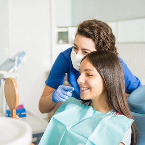Patient with braces smiling with orthodontist