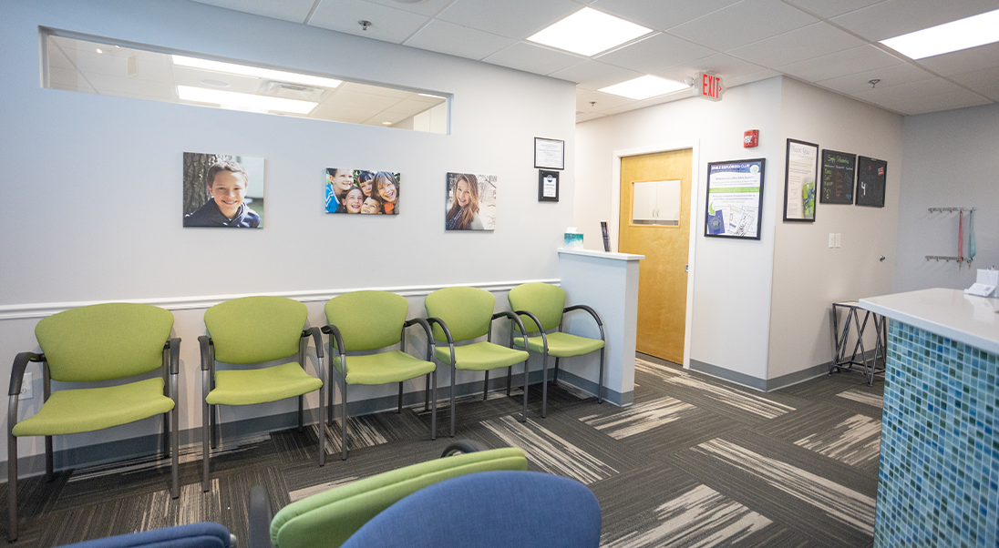 Row of light green chairs in the waiting area