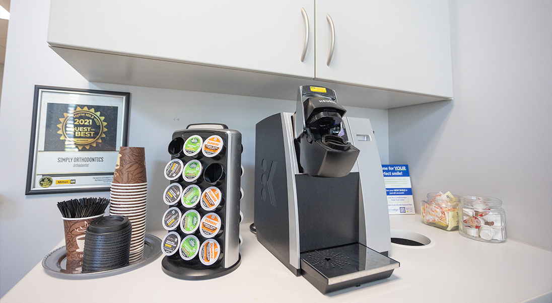 COffee maker next to a stack of coffee pods