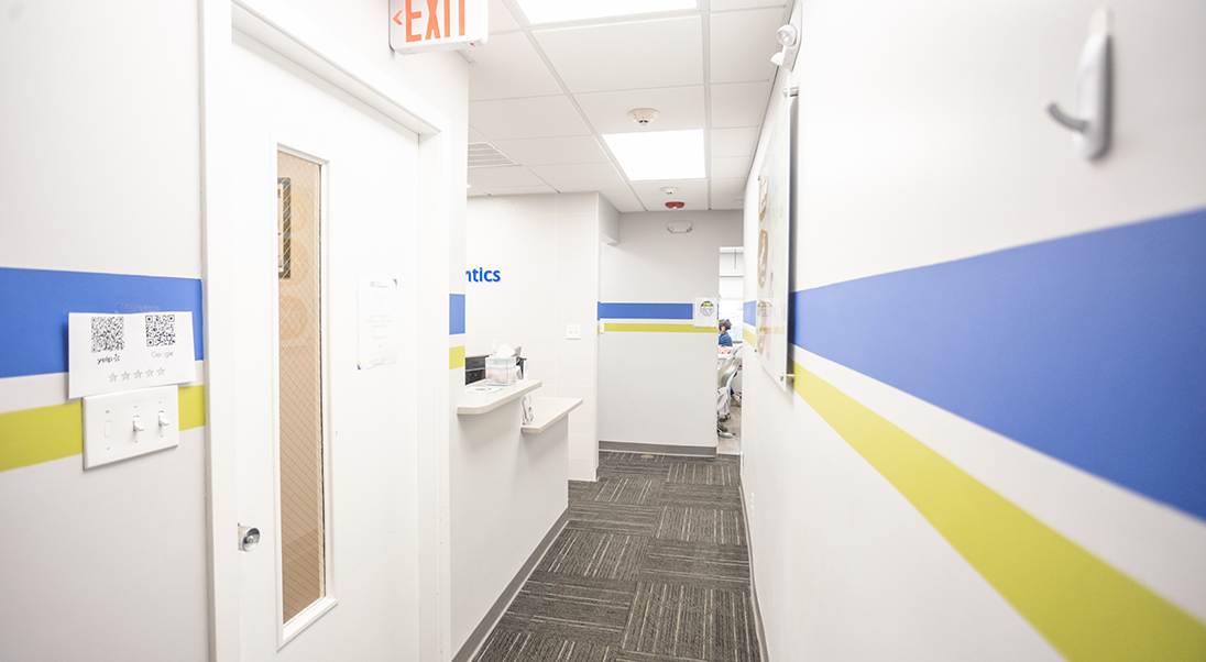 Hallway with white walls with green and blue stripes