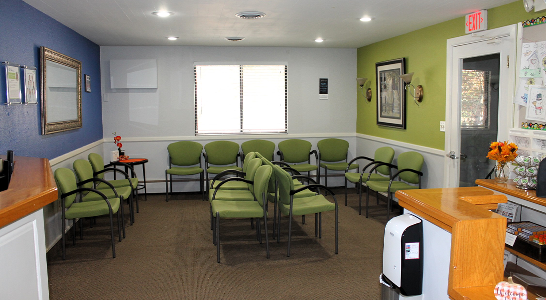 Rows of green chairs in the waiting area