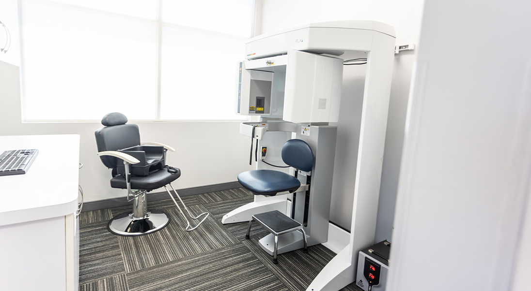 CT cone beam scanner standing against a wall