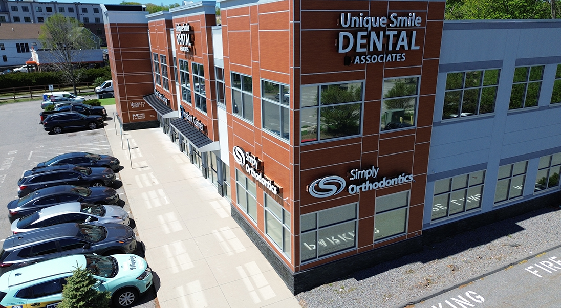 Aerial view of Simply Orthodontics Milford and the parking lot outside of it