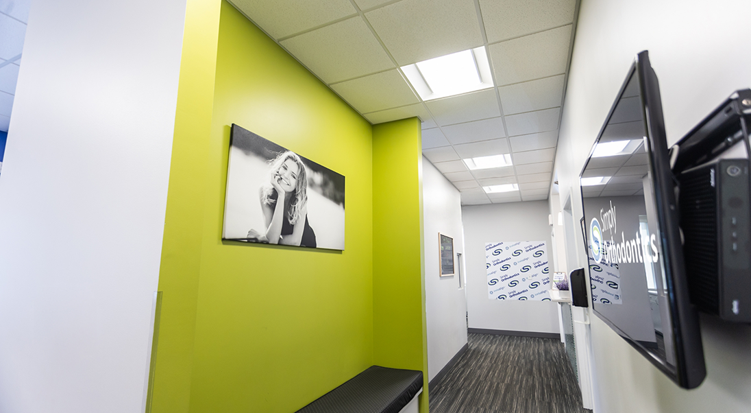 Hallway with photos of smiling people on the walls