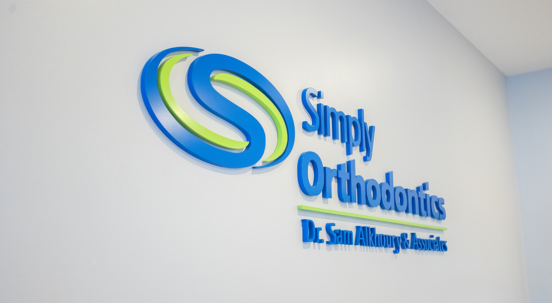 Wall sign that reads Simply Orthodontics Doctor Sam Alkhoury and Associates