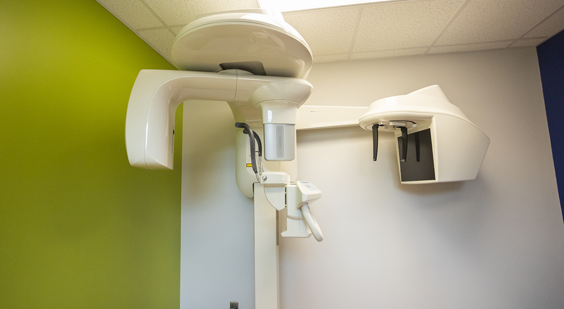 CT cone beam scanner standing against a wall