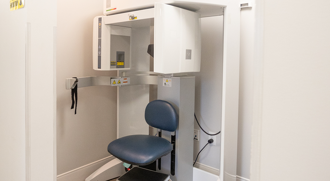 Cone beam CT scanner standing against a wall
