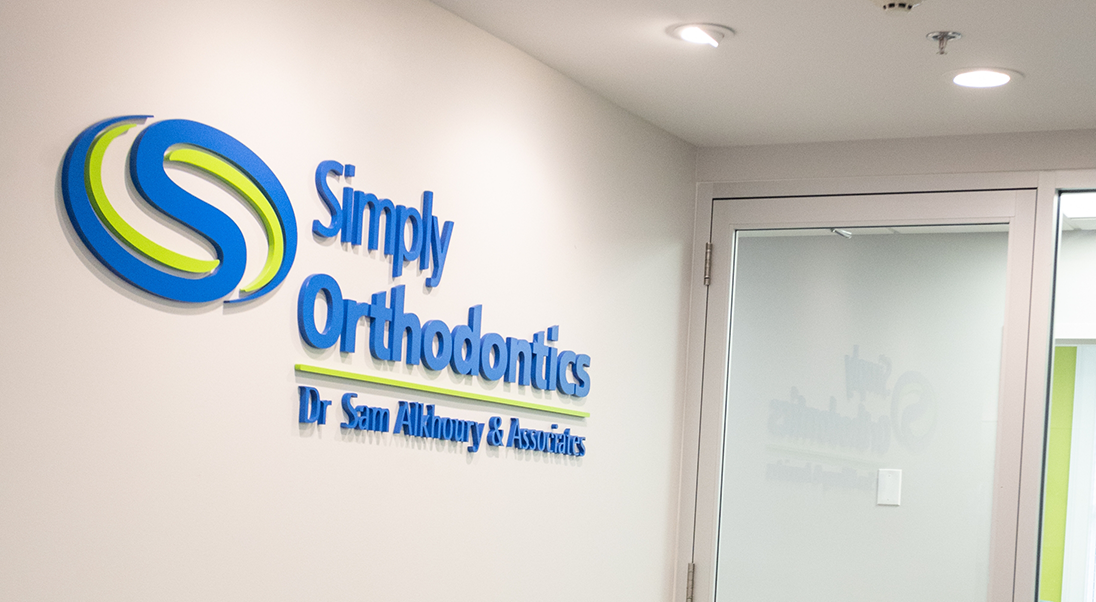 Wall sign that reads Simply Orthodontics Doctor Sam Alkhoury and Associates