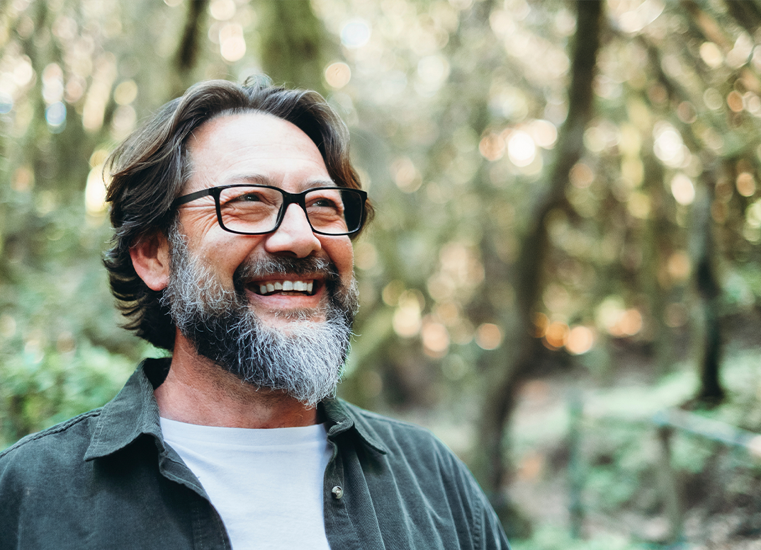 Older man smiling after seeing an orthodontist in Randolph
