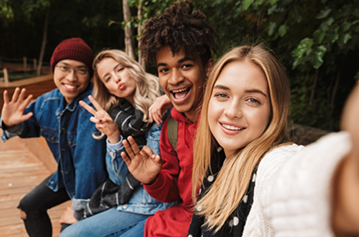 Selfie of several teenagers sitting on a bench