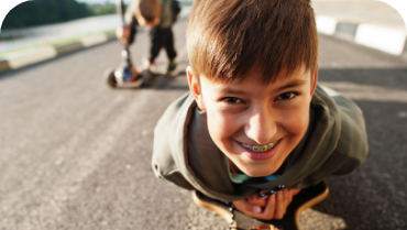 Young boy with braces grinning