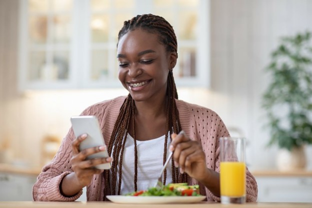Closeup of woman with braces smiling while eating