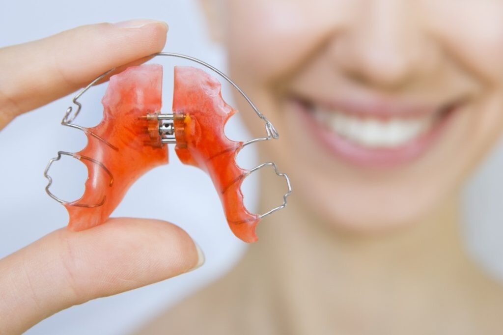 a patient holding their retainer