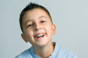 a child with braces smiling 