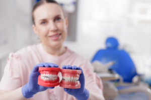 a dentist comparing ceramic braces with Invisalign aligners