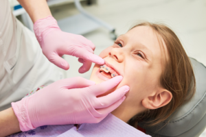 a child with braces smiling during an appointment