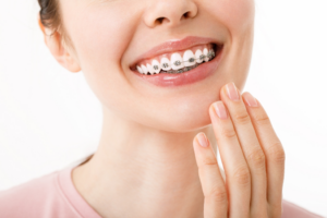 a patient with braces smiling confidently
