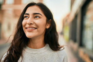 a patient with braces smiling confidently