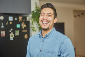 a patient with braces smiling confidently