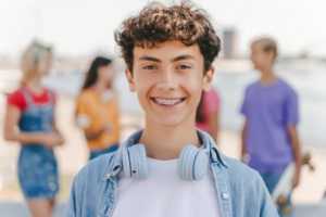 a teen with braces smiling 