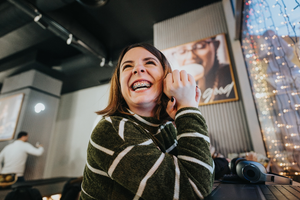 an adult with braces smiling at work