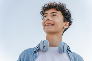 a teen with braces smiling
